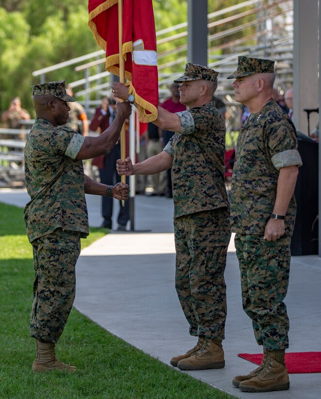 U.S. Marine Corps Sgt. Maj. James Porterfield, left, I Marine Expeditionary Force sergeant major, passes the I MEF battle colors to Lt. Gen. Lewis A. Craparotta, the outgoing commanding general of I MEF, during the I MEF change of command ceremony July 30, 2018, at Camp Pendleton, California. During the ceremony, Craparotta relinquished command of I MEF to Lt. Gen. Joseph L. Osterman. (U.S. Marine Corps photo by Cpl. Jacob A. Farbo)