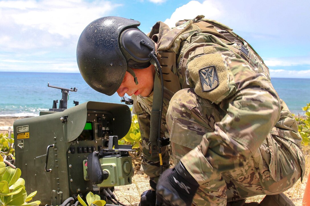A soldier prepares a remote control apparatus for the Avenger air defense system.