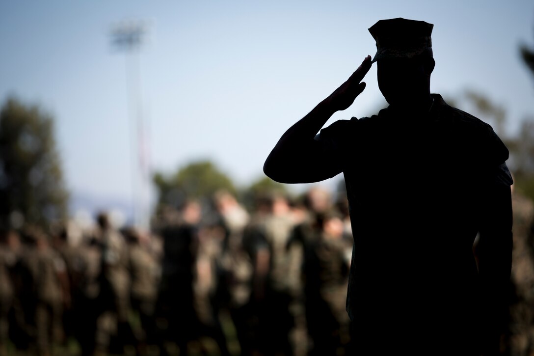 A U.S. Marine salutes during the I Marine Expeditionary Force change of command ceremony held at Camp Pendleton, California, July 30, 2018. During the ceremony, Lt. Gen. Lewis A. Craparotta relinquished command of I MEF to Lt. Gen. Joseph L. Osterman. (U.S. Marine Corps photo by Lance Cpl. Dalton S. Swanbeck)