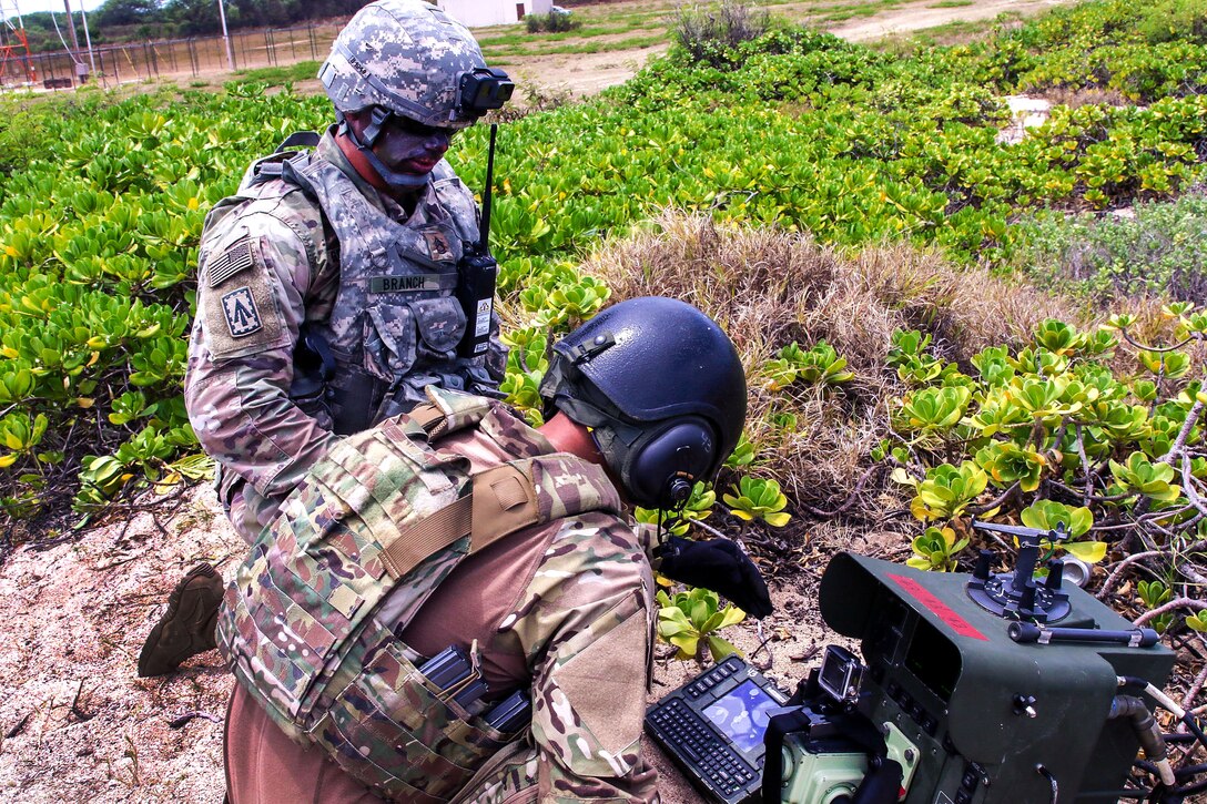 Soldiers conduct their final checks on a remote control apparatus.