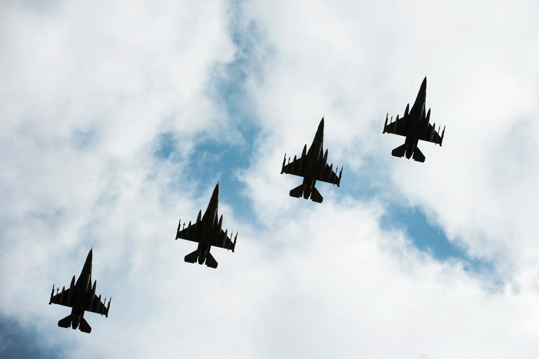 Four F-16C Fighting Falcons fly in formation.