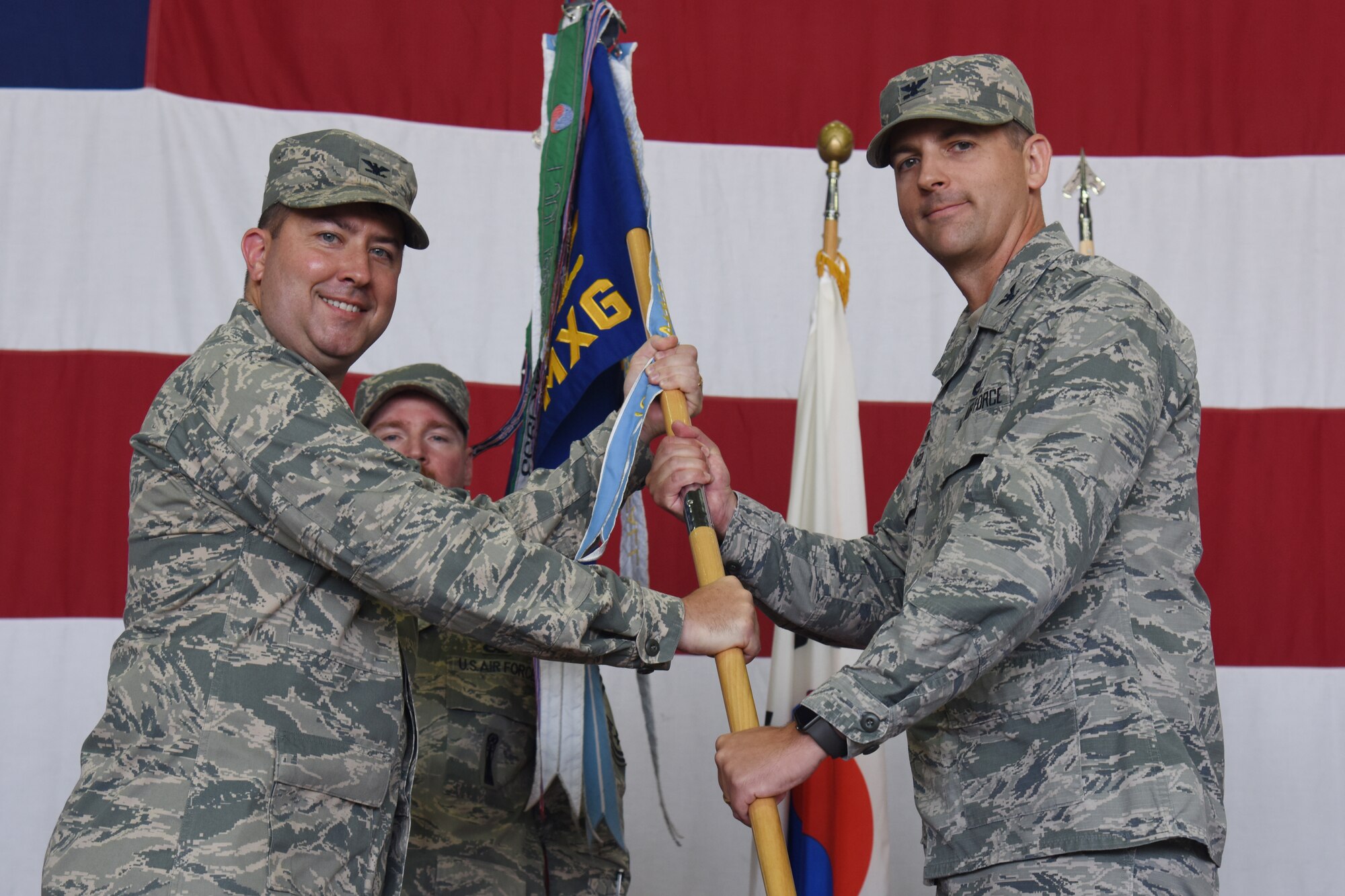 Col. James T. Vinson accepts the guideon during the 51st Maintenance Group Change of Command ceremony at Osan Air Base, Republic of Korea July 20, 2018. Vinson was commissioned through the Reserve Officer Training Corps program in June of 1996. A career aircraft maintenance officer, he served in a variety of positions at Wing, Major Command, Headquarters Air Force, and Office of the Secretary of Defense levels. Vinson’s previous assignment was Military Deputy, Office of the Deputy Assistant Secretary of Defense for Supply Chain Integration in Washington D.C.