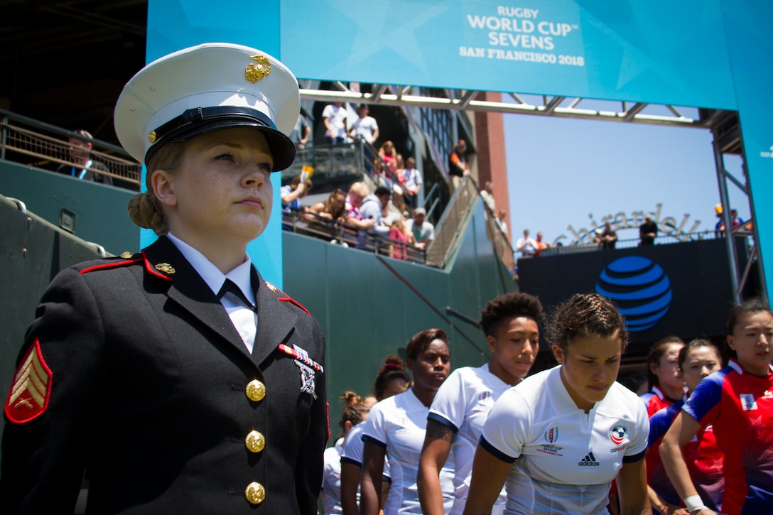 Sgt. Nichole Stoehrer, a marketing and communication Marine at Recruiting Station San Francisco, stands in the honor guard to welcome the USA Rugby women’s team onto the pitch during the Rugby World Cup Sevens in San Francisco, July 20, 2018. This year, the Marine Corps attended the Rugby World Cup Sevens as part of its partnership with USA Rugby. Rugby players tend to share the fighting spirit embodied in Marines and by partnering with USA Rugby, the national governing body for the sport in America, the Marine Corps will reach a broad cross-section of high school and collegiate-aged rugby players as well as an ever-growing influencer network of coaches, referees, rugby alumni and parents. Stoehrer is from Rutherfordton, North Carolina, and to the right of Stoehrer stands Nicole Heavirland, a native of Whitefish, Montana.