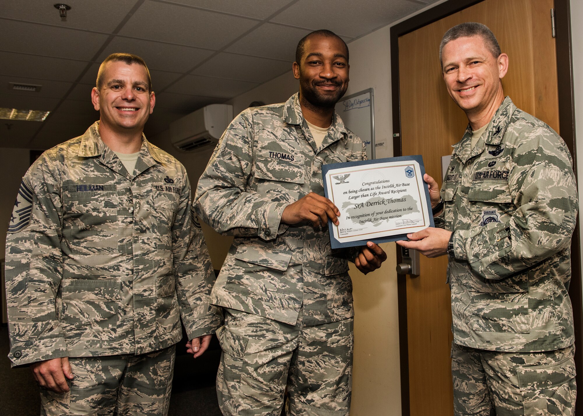 U.S. Air Force Senior Airman Derrick Thomas poses with his Larger Than Life Award at Incirlik Air Base, Turkey, July 31, 2018.