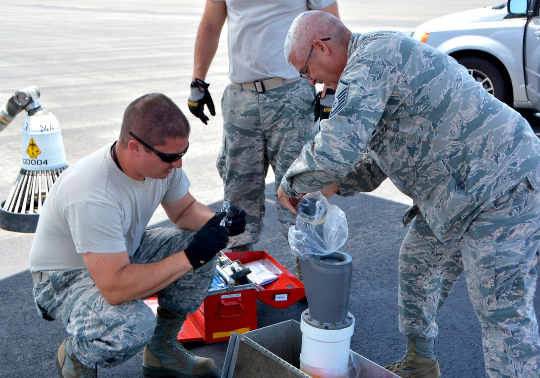 507th Aircraft Maintenance Squadron Master Sgts. Ben Peterson, electrician, and David Wallis, propulsion mechanic, prepare to attach a hose-and-drogue to a KC-135R Stratotanker July 9, in support of the Rim of the Pacific (RIMPAC) exercise. Twenty-five nations, 46 ships, five submarines, and about 200 aircraft and 25,000 personnel are participating in RIMPAC from June 27 to Aug. 2 in and around the Hawaiian Islands and Southern California. The world’s largest international maritime exercise, RIMPAC provides a unique training opportunity while fostering and sustaining cooperative relationships among participants critical to ensuring the safety of sea lanes and security of the world’s oceans. RIMPAC 2018 is the 26th exercise in the series that began in 1971. (U.S. Air Force photo by Tech. Sgt. Samantha Mathison)