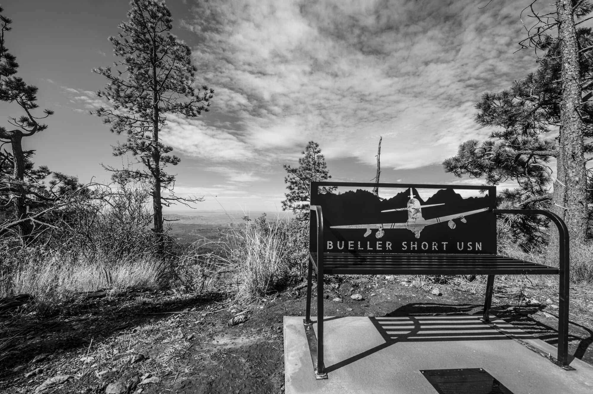 In memory of Lt. Christopher “Bueller” Short, U.S. Navy pilot, a bench was placed at the end of the Rim Trail in the Tularosa Basin, N.M., July 13, 2018. Short lost his life when an A-29 Super Tucano crashed over the Red Rio Bombing Range, June 22, 2018. (U.S. Air Force photo illustration by Senior Airman Chase Cannon)