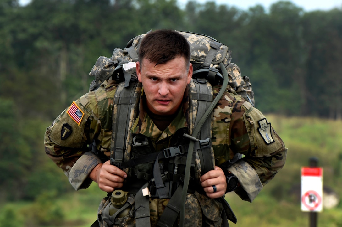A soldier runs along a road during the ruck march event.