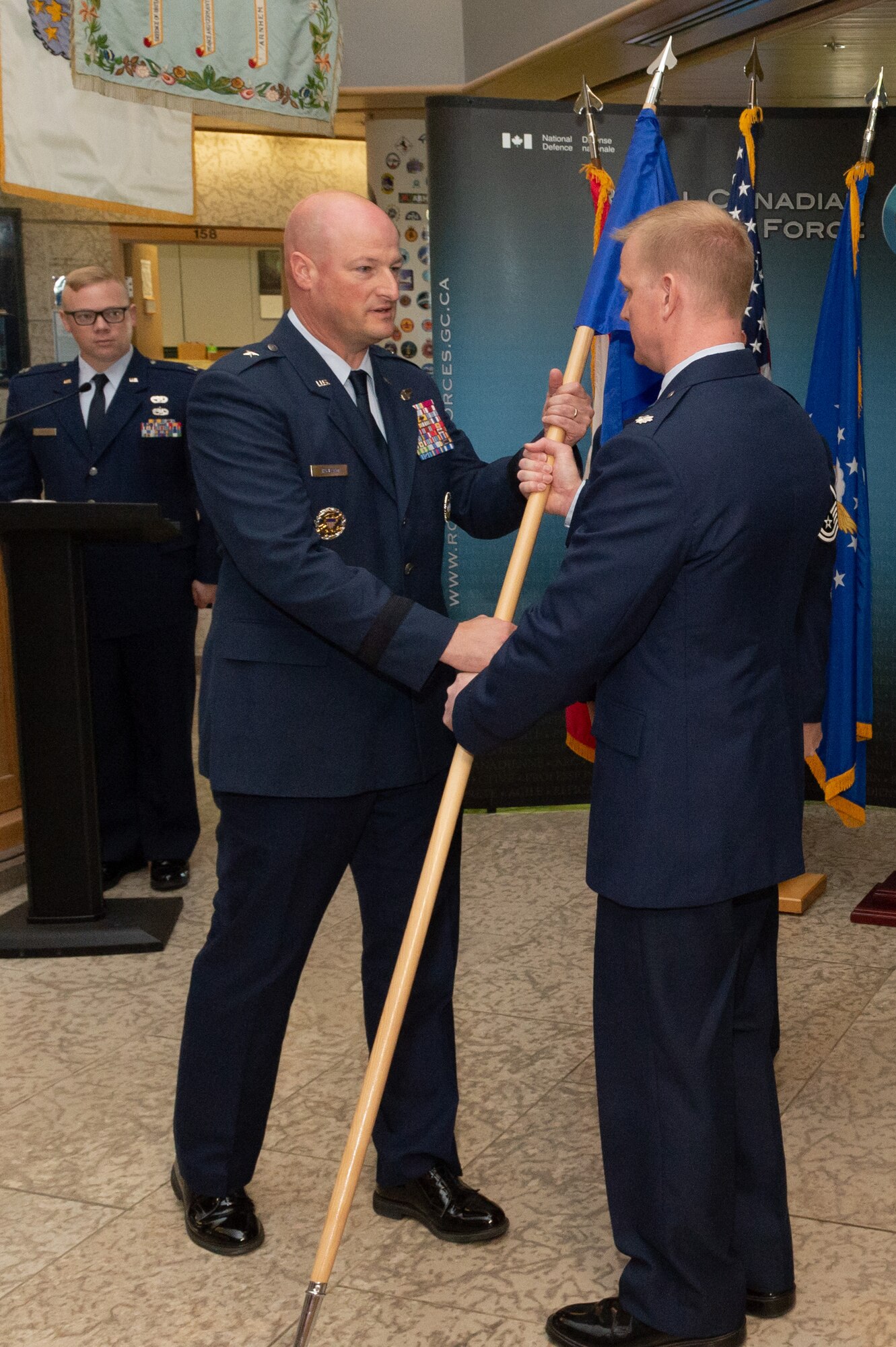 NORAD Deputy Commander Canadian region, Brigadier General Christopher Ireland receives the flag from outgoing Detachment 1 Commander, Lieutenant Colonel Ethan McKenna who relinquishes command during the Det 1, First Airforce change of command ceremony on June 18th, 2018 at 1 CAD, Winnipeg.

Photo by: Cpl Bryce Cooper, 17 Wing Imaging