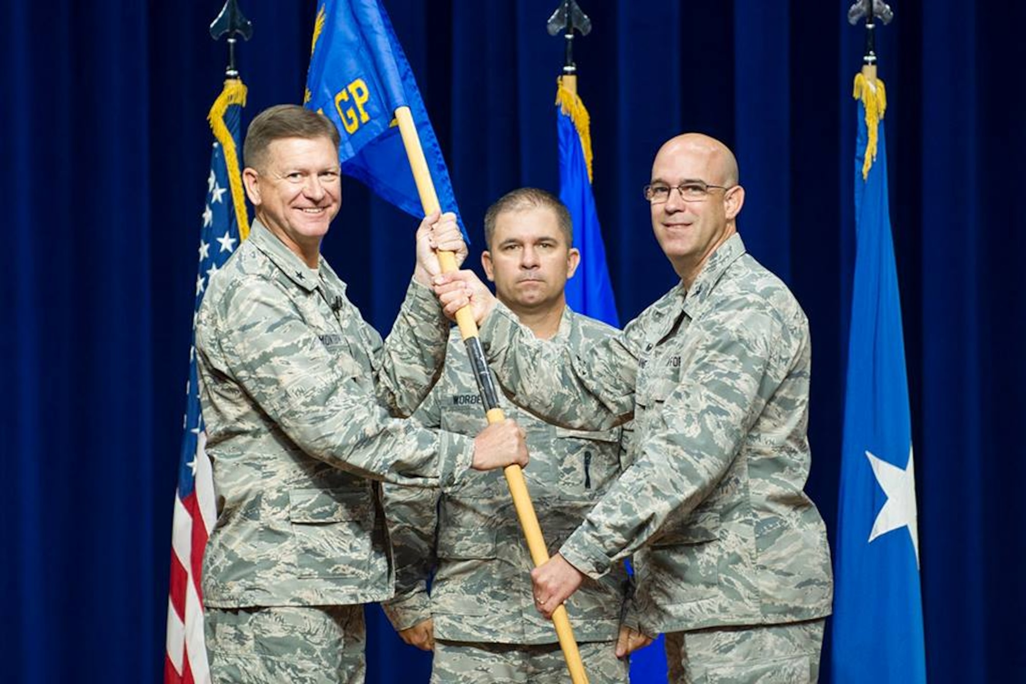 Brig. Gen. Wayne Monteith, commander of the 45th Space Wing, presents Col. Steven Lang, commander of the 45th Operations Group, with the 45th OG guidon, July 31, 2018 at Patrick Air Force Base, Fla. The 45th Launch Group inactivated and combined their launch mission and personnel with the 45th OG. (U.S. Air Force photo by Phillip Sunkel)
