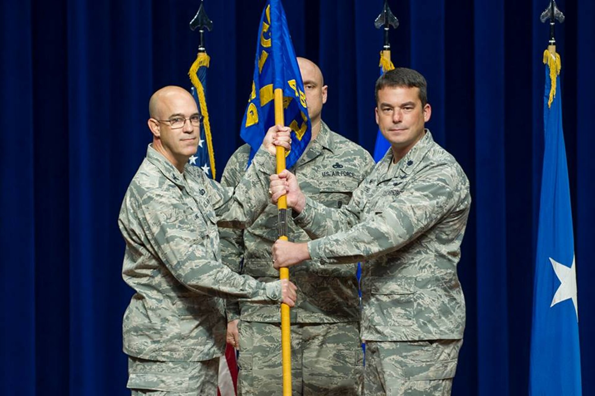 Col. Steven Lang, commander of the 45th OG, presents Lt. Col. Waylon Mitchell, commander of the 5th Space Launch Squadron, with the 5th SLS guidon, July 31, 2018 at Patrick Air Force Base, Fla. The 45th Launch Support Squadron inactivated and merged, combining their launch mission and personnel into the 5th Space Launch Squadron. (U.S. Air Force photo by Phillip Sunkel)