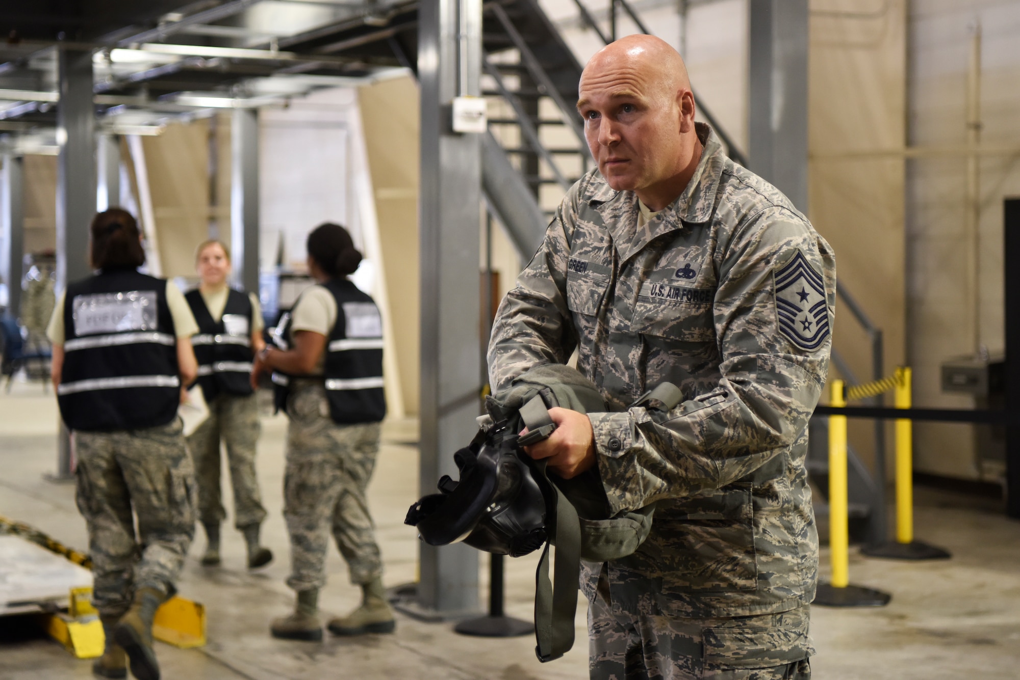 Chief Master Sgt. Anthony Green, 436th Airlift Wing command chief, checks his gas mask for all the necessary pieces during exercise Vengeant Eagle 2.0 July 25, 2018, at Dover Air Force Base, Del. The exercise’s main goal was to evaluate the wing’s readiness to respond to real-world contingencies. (U.S. Air Force photo by Airman 1st Class Zoe M. Wockenfuss)