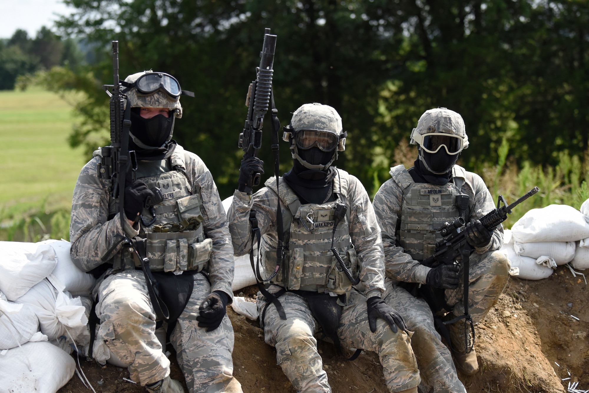 From left, Staff Sgt. Alexander Oelfke, Airman 1st Class Ryan Makaipo and Staff Sgt. Joshua Medlin, 436th Security Forces Squadron defenders, participate in exercise Vengeant Eagle 2.0 July 25, 2018, at Dover Air Force Base, Del. During the exercise they fired simunition rounds during a simulated engagement with enemy forces. (U.S. Air Force photo by Airman 1st Class Zoe M. Wockenfuss)
