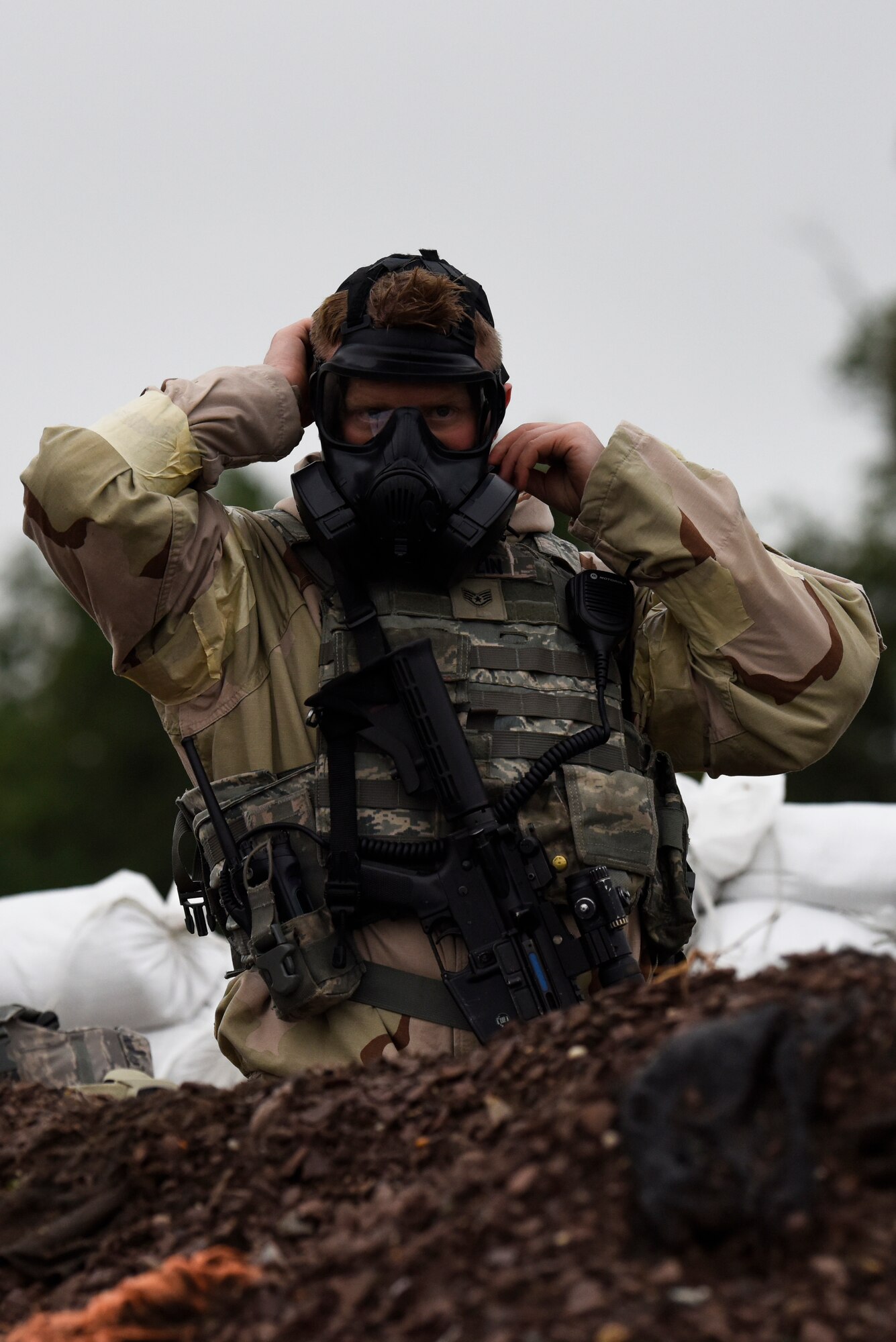 Staff Sgt. Joshua Medlin, 436th Security Forces Squadron defender, dons his Mission-Oriented Protective Posture equipment during exercise Vengeant Eagle 2.0 July 25, 2018, at Dover Air Force Base, Del. MOPP gear provides protection from chemical, biological, radiological and nuclear agents. (U.S. Air Force photo by Airman 1st Class Zoe M. Wockenfuss)