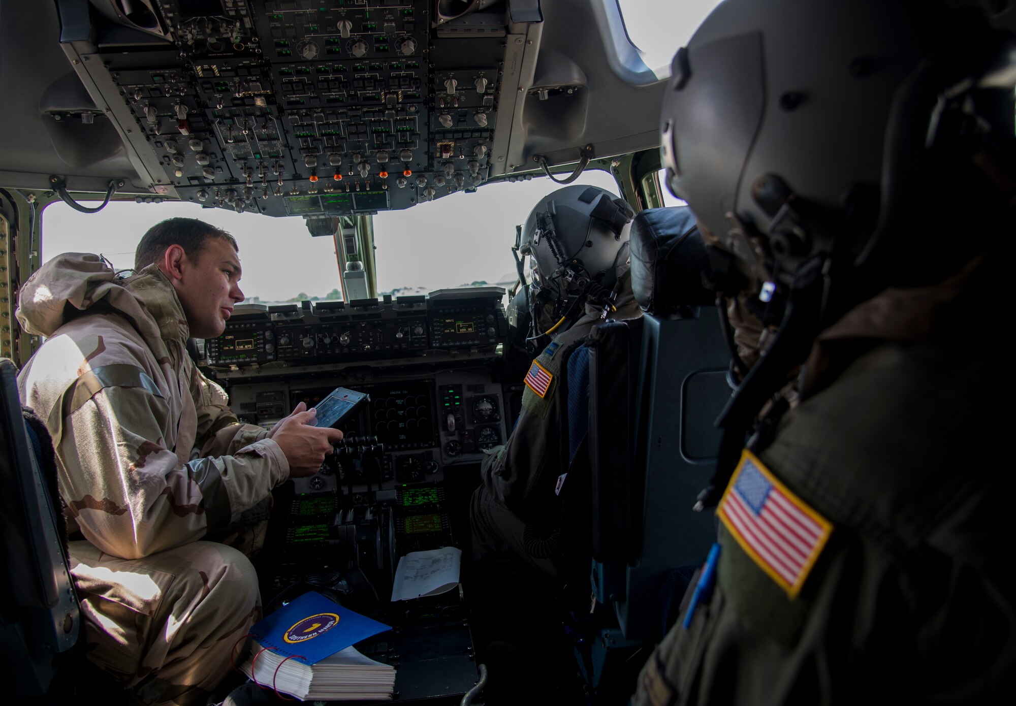 Capt. Robert Isley, 3rd Airlift Squadron C-17 Globemaster III pilot, runs pre-flight checks while wearing Mission Oriented Protective Posture gear during exercise Vengeant Eagle 2.0 on July 26, 2018, at Dover Air Force Base, Del. This small-scale readiness exercise was designed to test chemical, biological, radiological and nuclear hazard defensive measures. (U.S. Air Force photo by Tech. Sgt. Laura Beckley)