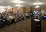 Rear Adm. Sean Buck delivers opening remarks.