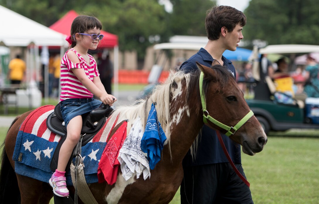 A Fort Eustis 100th Anniversary Open House attendee rides a pony at Joint Base Langley-Eustis, Virginia, July 28, 2018.