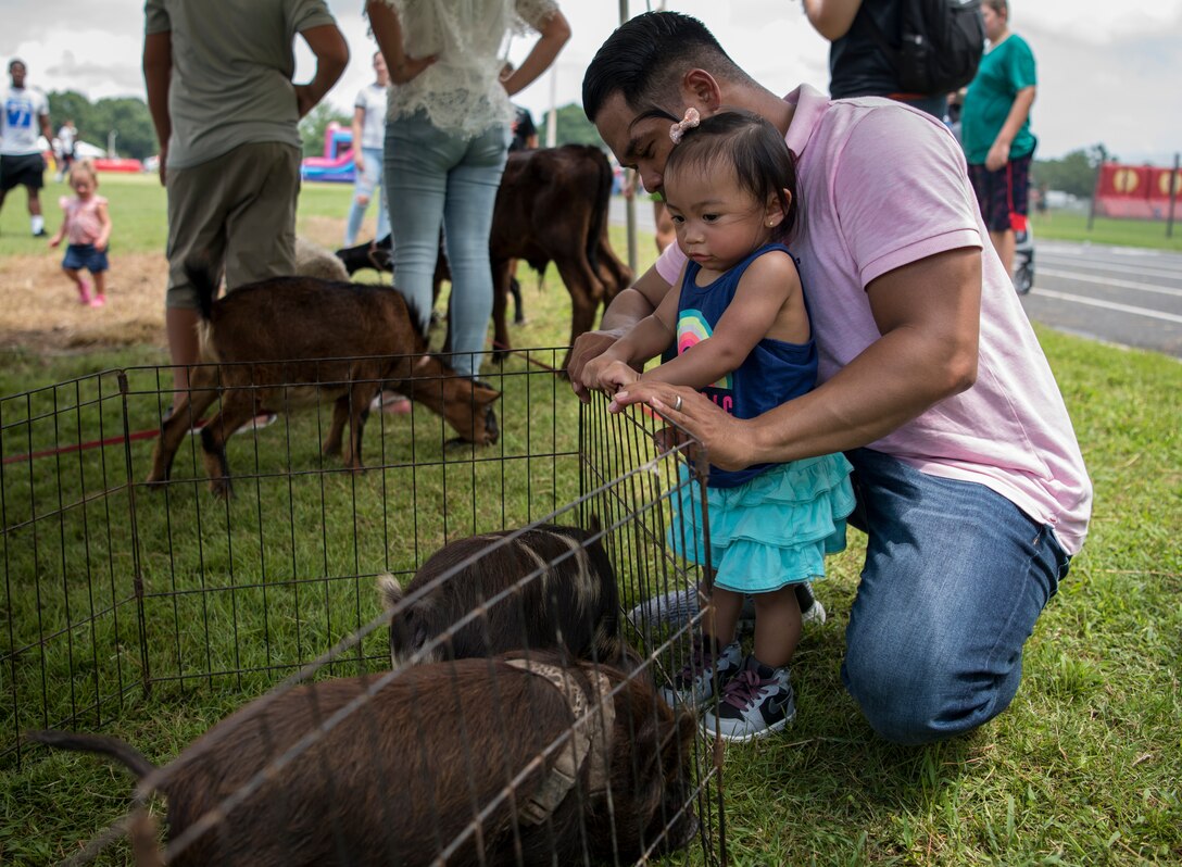 Fort Eustis Open House attendees look at a petting zoo as part of the installation's 100th Anniversary Celebration at Joint Base Langley Eustis, Virginia, July 28, 2018.