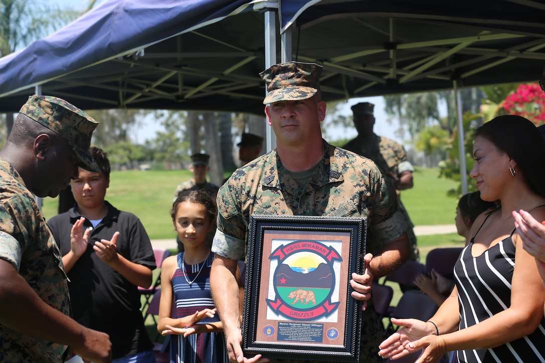 U.S. Marine Corps Master Sgt. Geanni Zillinger, station food service technical representative, receives a plaque from Headquarters and Headquarters Support Squadron during his retirement ceremony at Marine Corps Air Station Miramar, Calif., July 27. Zillinger retired after serving 26 years of honorable military service. (U.S. Marine Corps photo by Sgt. Daniel Auvert/ Released)