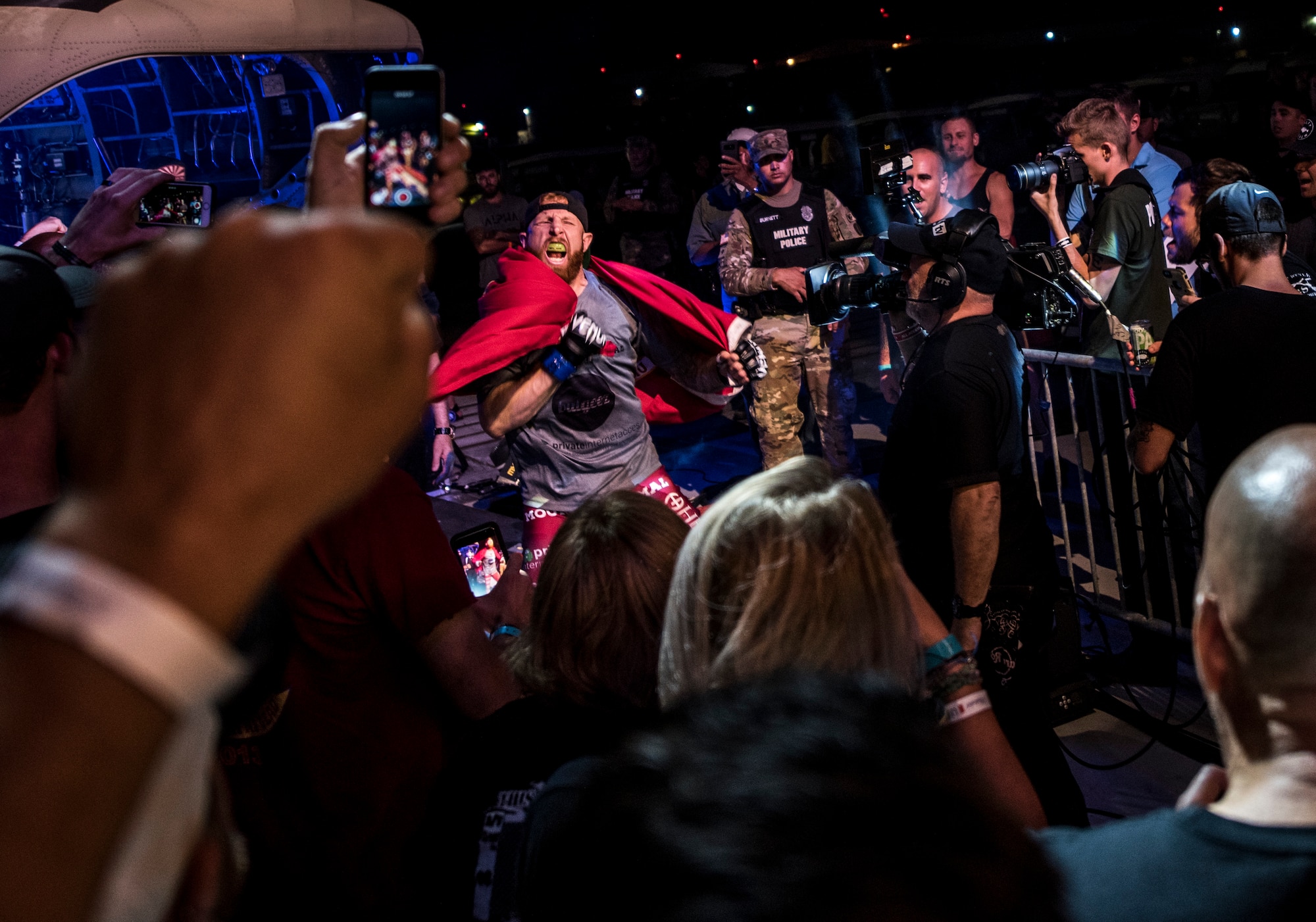 Center, Kyle "Gunz Up" Stewart, mixed martial arts athlete, approaches the octagon during the Legacy Fighting Alliance live broadcast at Joint Base Langley-Eustis, Virginia, July 27, 2018.