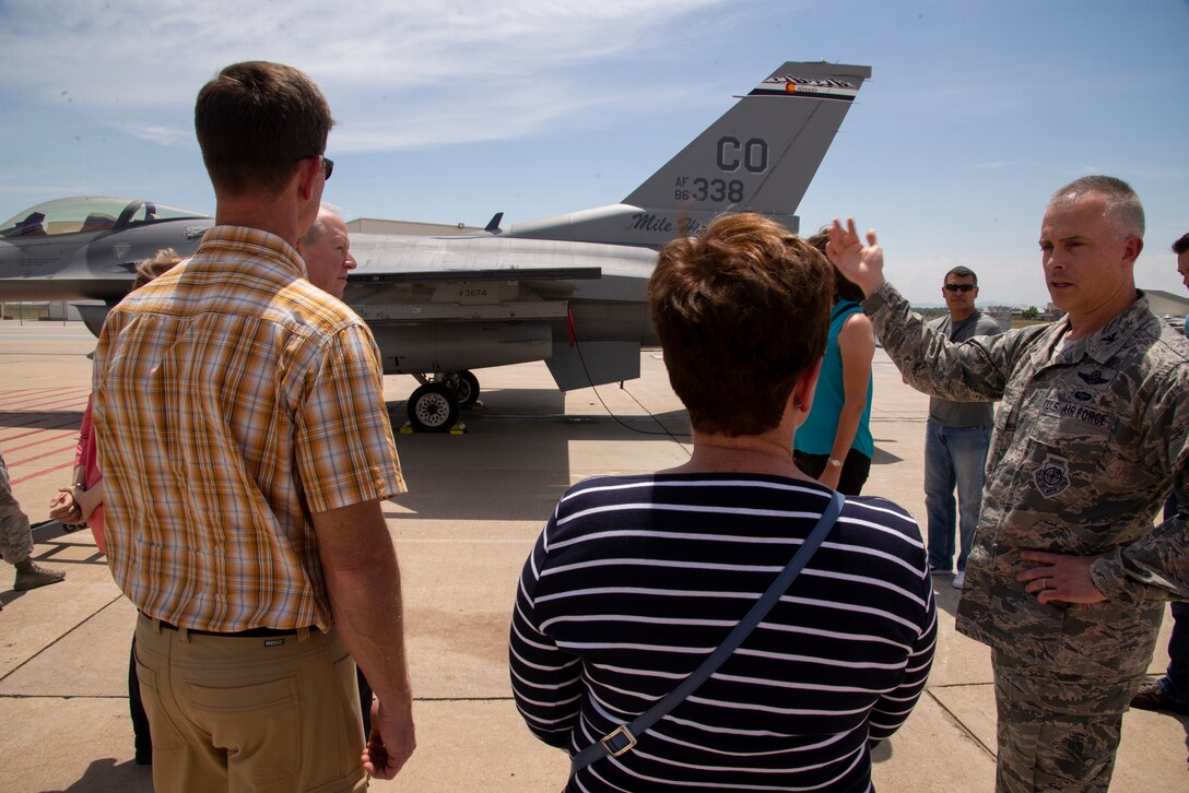Col. Brian Turner, the Colorado Air National Guard’s 140th Wing commander, explains the capabilities of an F-16 Fighting Falcon aircraft to civic leaders participating in the 302nd Airlift Wing’s Partners in Leadership program during a visit to Buckley Air Force Base, Colorado, July 20, 2018.
