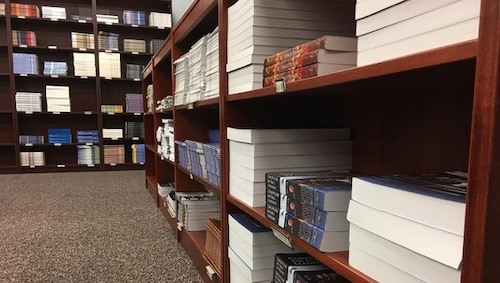 Bookshelves neatly stacked with Air University Press books and research papers
