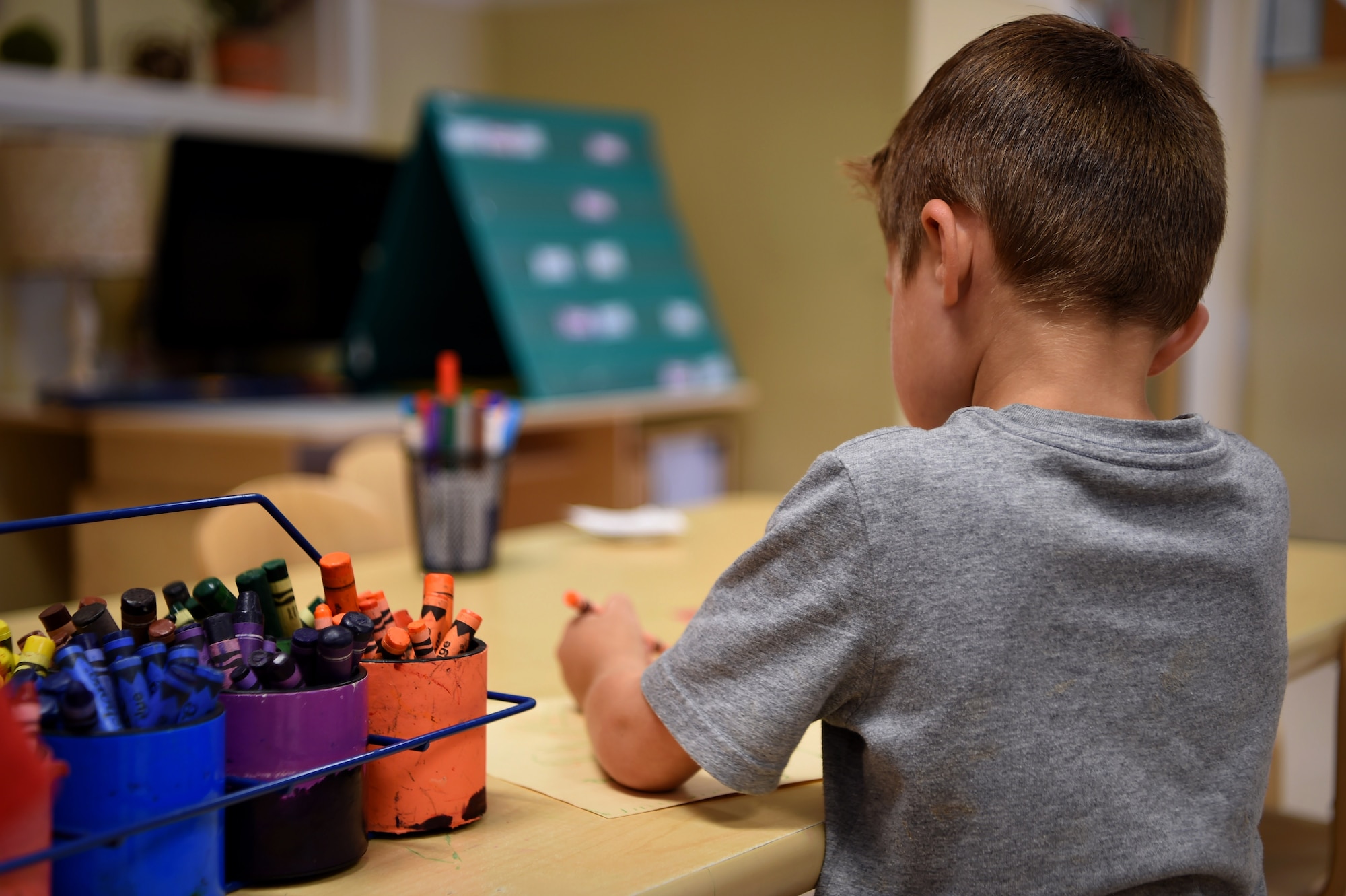 A child participates in arts and crafts at the Child Development Center, July 26, 2018, on Buckley Air Force Base, Colorado. The CDC staff supports the development of the whole child and provides active, hands on learning experiences to meet the individual needs of each child in the program. (U.S. Air Force photo by Airman 1st Class Codie Collins)