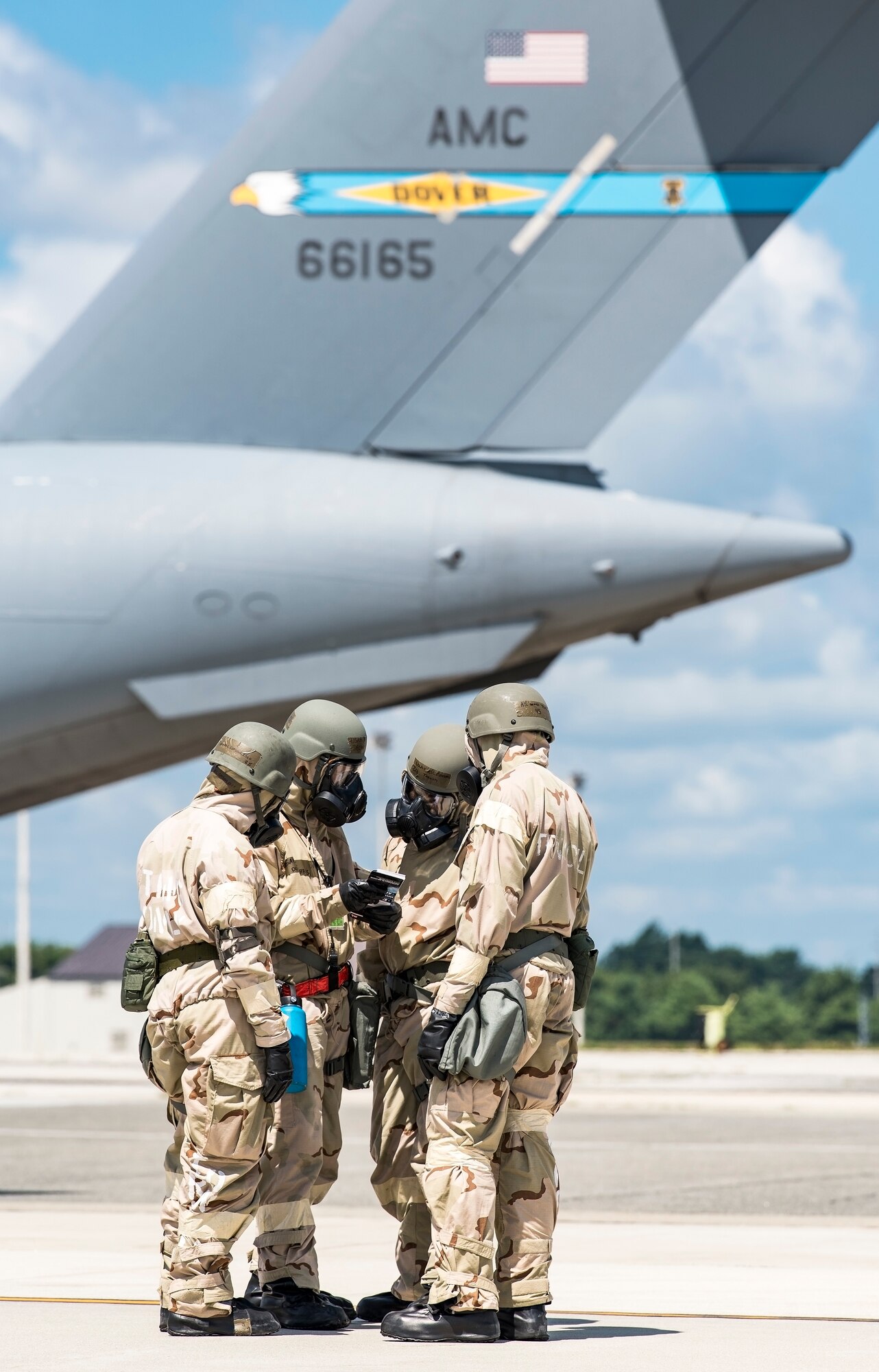 Team Dover members review the procedures before walking around a C-17 Globemaster III in Mission Oriented Protection Posture gear July 26, 2018, at Dover Air Force Base, Del. More than 250 Team Dover Airmen participated in exercise Vengeant Eagle 2.0. (U.S. Air Force photo by Roland Balik)