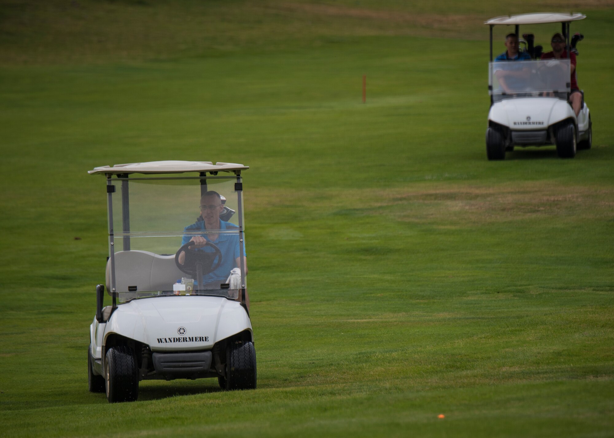 U.S. Air Force Chief Master Sgt. Lee Mills, 92nd Air Refueling Wing command chief, leads his team to the next golf hole during the 24th Annual Operation Warmheart Golf Tournament at Wandermere Golf Course in Spokane, Washington, July 27, 2018. Fairchild Airmen participated in the tournament to raise money to provide goods and support for Airmen and their families when facing difficult times. (U.S. Air Force photo/ Airman 1st Class Whitney Laine)
