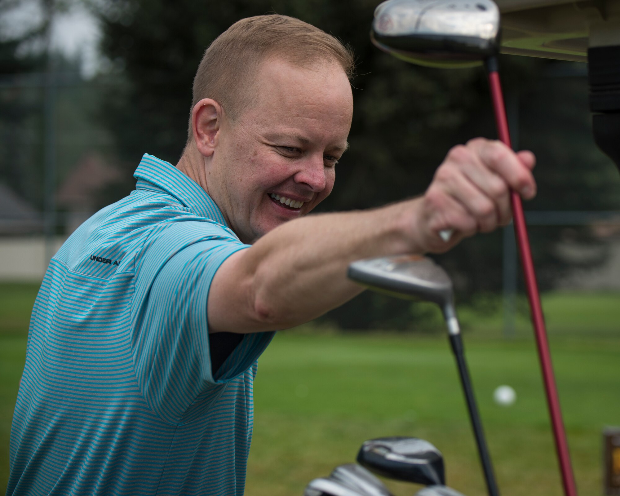 U.S. Air Force Col. Derek Salmi, 92nd Air Refueling Wing commander, selects a golf club during the 24th Annual Operation Warmheart Golf Tournament at Wandermere Golf Course in Spokane, Washington, July 27, 2018. Operation Warm Heart is a program offered by first sergeants to assist military members and their families during the holidays and throughout the year, specifically to purchase food items and aid in emergencies during difficult times. (U.S. Air Force photo/ Airman 1st Class Whitney Laine)