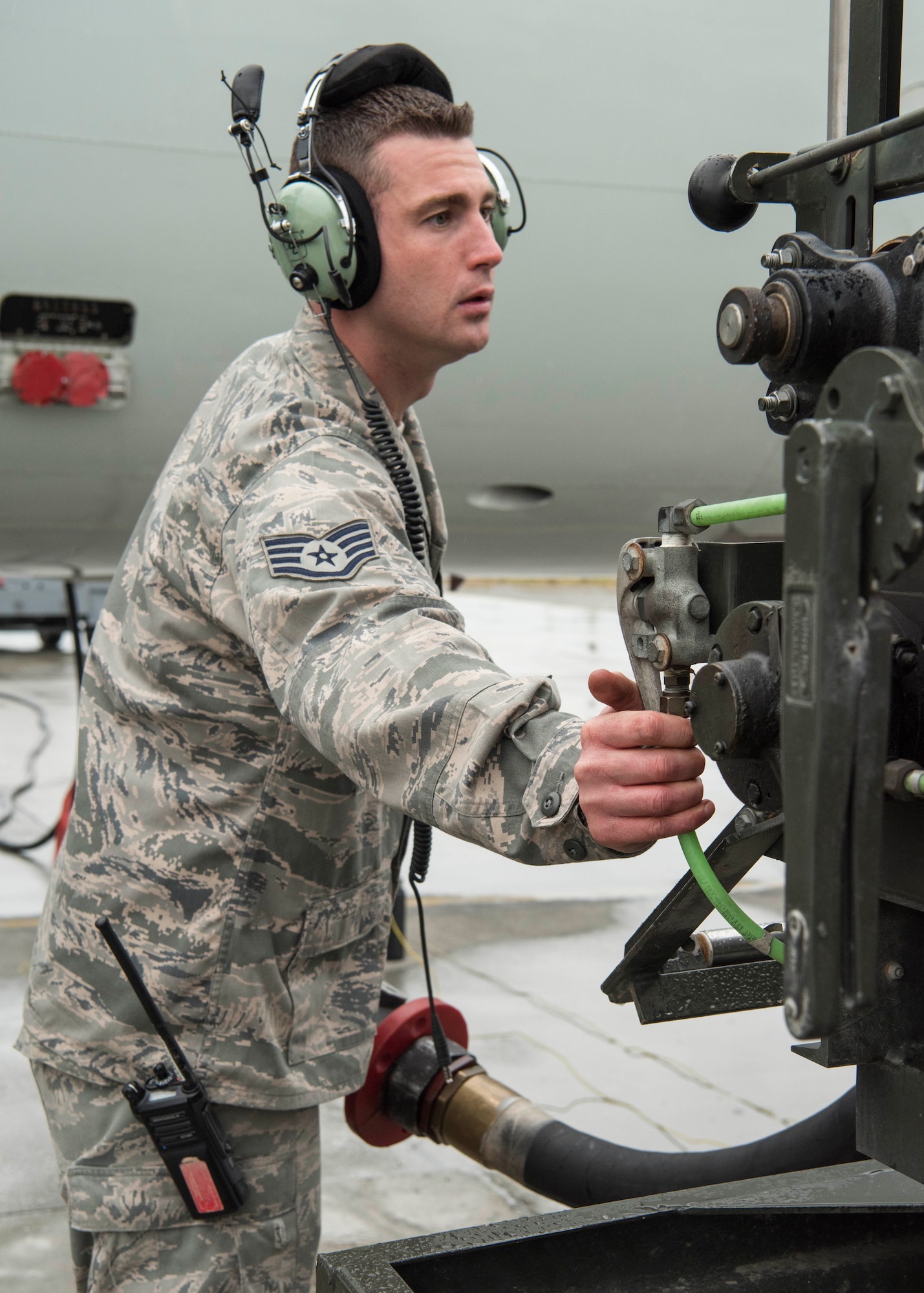 U.S. Air Force Staff Sgt. Matthew Kennedy, a 962nd Aircraft Maintenance Unit E-3 Sentry crew chief, reels in a fuel hose after refueling an E-3 Sentry at Joint Base Elmendorf-Richardson, Alaska, July 25, 2018. Kennedy is responsible for service and repair on everything coming back from daily inspections, to include things like oil, hydraulics and fueling the jet.