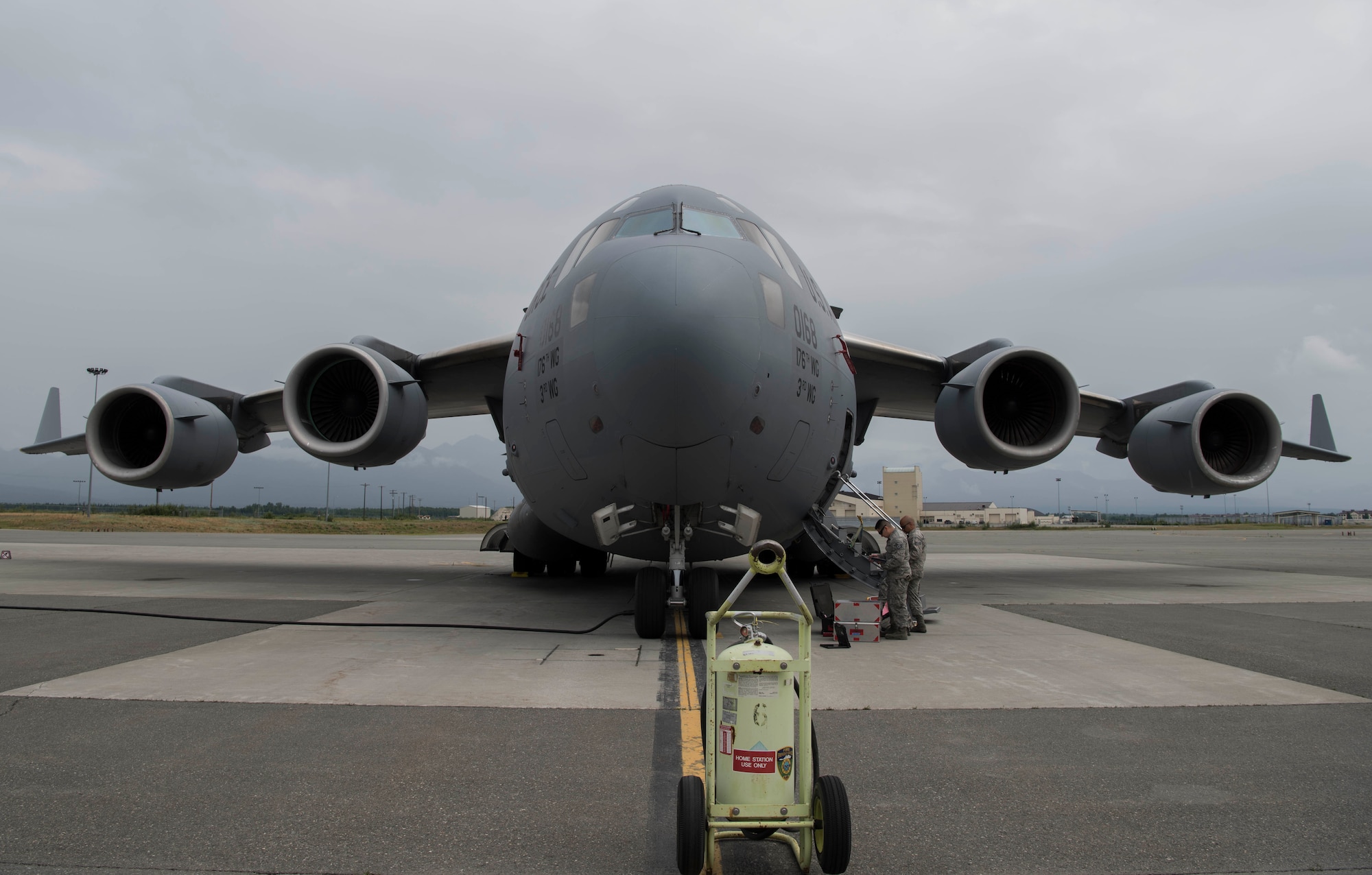U.S. Air Force Staff Sgt. Silvestre Rojas and Senior Airman Michael Ela, both 517th Aircraft Maintenance Unit communication navigations specialists, load flare magazines onto a C-17 Globemaster III at Joint Base Elmendorf-Richardson, Alaska, July 26, 2018. During this process, the aircraft is cordoned off and the specialists test the flare dispensers for functionality.