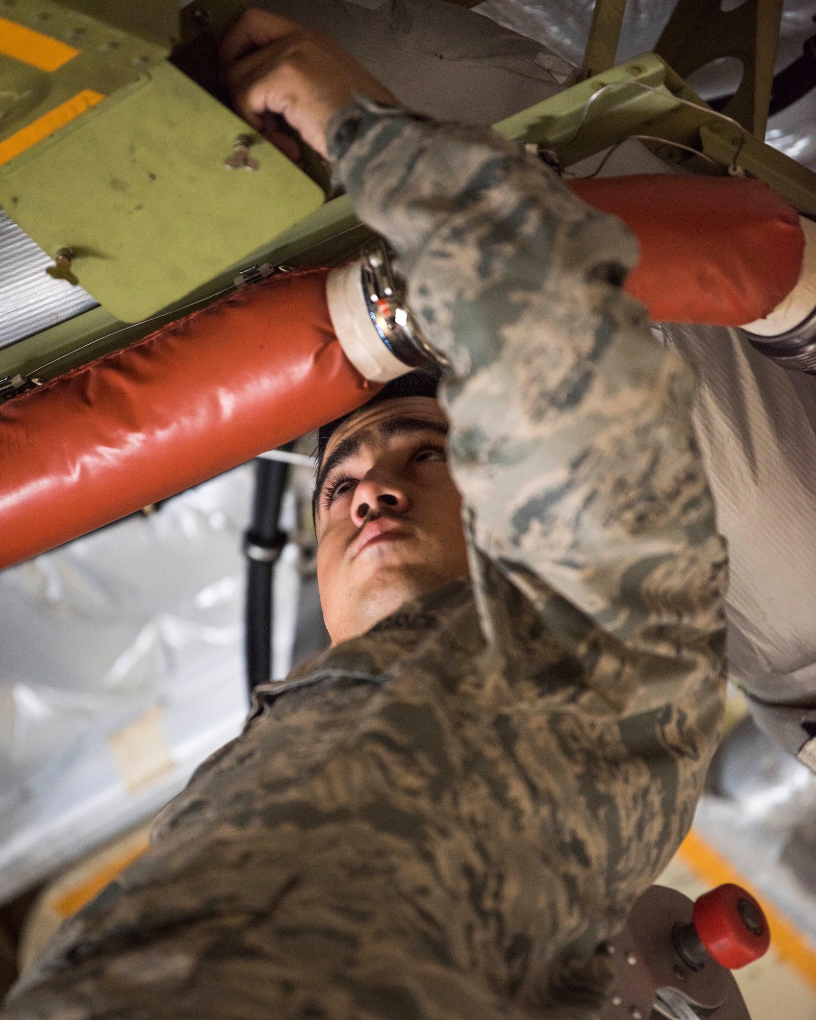 U.S. Air Force Staff Sgt. Caleb Langel, a 517th Aircraft Maintenance Unit C-17 Globemaster III dedicated crew chief, inspects a life raft pressure gauge at Joint Base Elmendorf-Richardson, Alaska, July 26, 2018. Langel is responsible for service and repairs on everything coming back from daily inspections, including making sure the life raft pressure gauge meets specifications to fully inflate if needed.