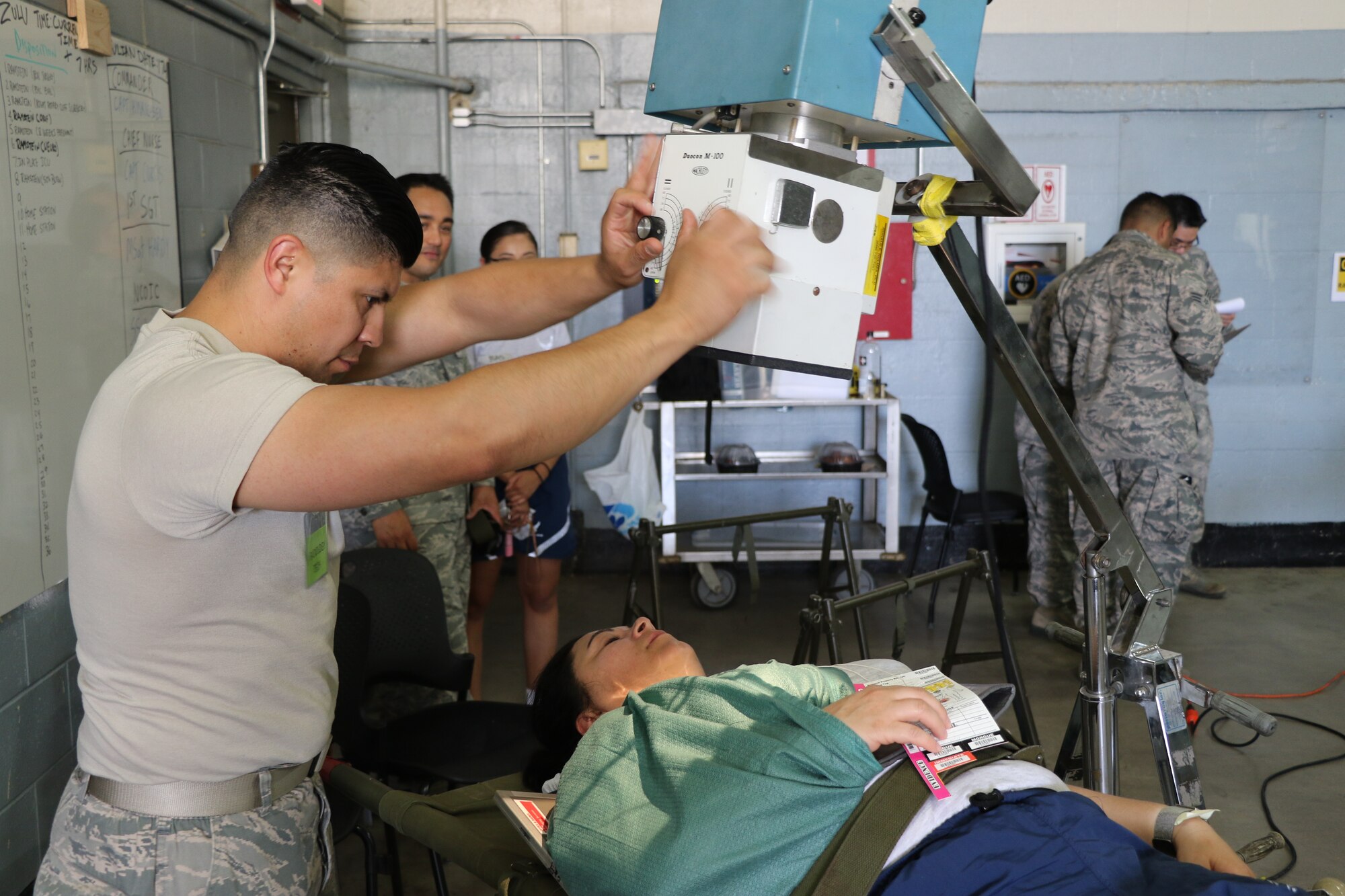 U.S. Air Force Tech. Sgt. Juan Morales, diagnostic imaging technician with the 752nd Medical Squadron, March Air Reserve Base, operates a portable X-ray machine on a simulated injured patient in the Joint Medical Training Center here June 23, 2018.