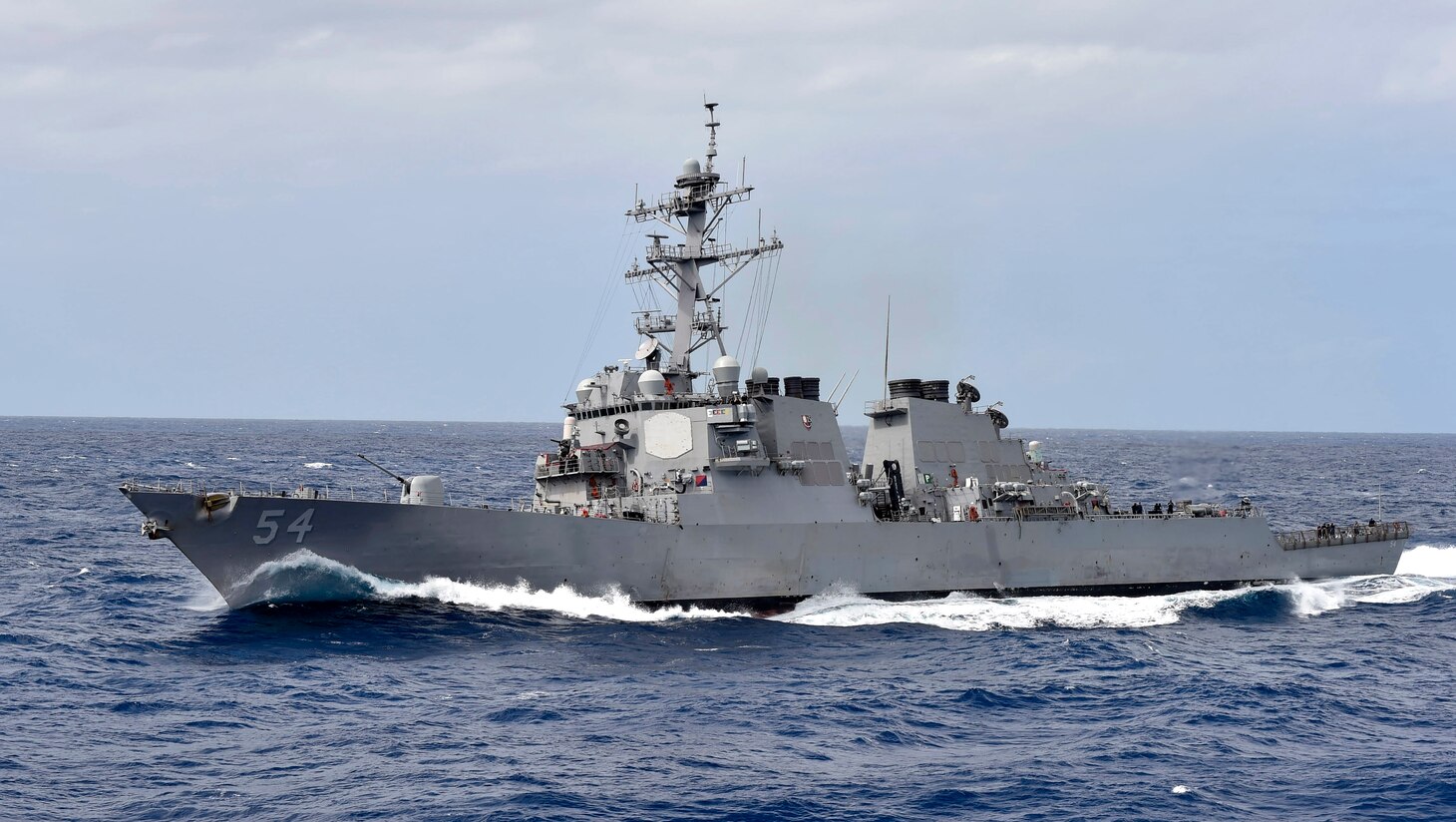 FILE PHOTO of The Arleigh Burke-class guided-missile destroyer USS Curtis Wilbur (DDG 54). Wilbur is forward-deployed to the U.S. 7th Fleet area of operations in support of security and stability in the Indo-Pacific region. (U.S. Navy photo by Mass Communication Specialist 1st Class Benjamin Dobbs/Released)