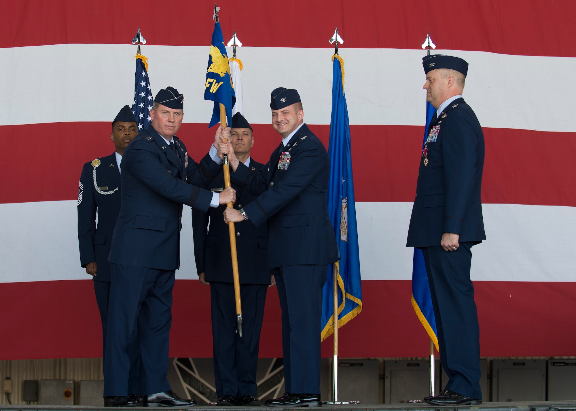 U.S. Air Force Lt. Gen. Thomas Bergeson, 7th Air Force commander, presents the 8th Fighter Wing guidon to Col. John W. Bosone, 8th Fighter Wing commander, during a change of command ceremony at Kunsan Air Base, Republic of Korea, June 1, 2018. During the ceremony, Bosone assumed command of the 8th Fighter Wing, stepping into the position of his predecessor, Col. David G. Shoemaker. (U.S. Air Force photo by Staff Sgt. Victoria H. Taylor)