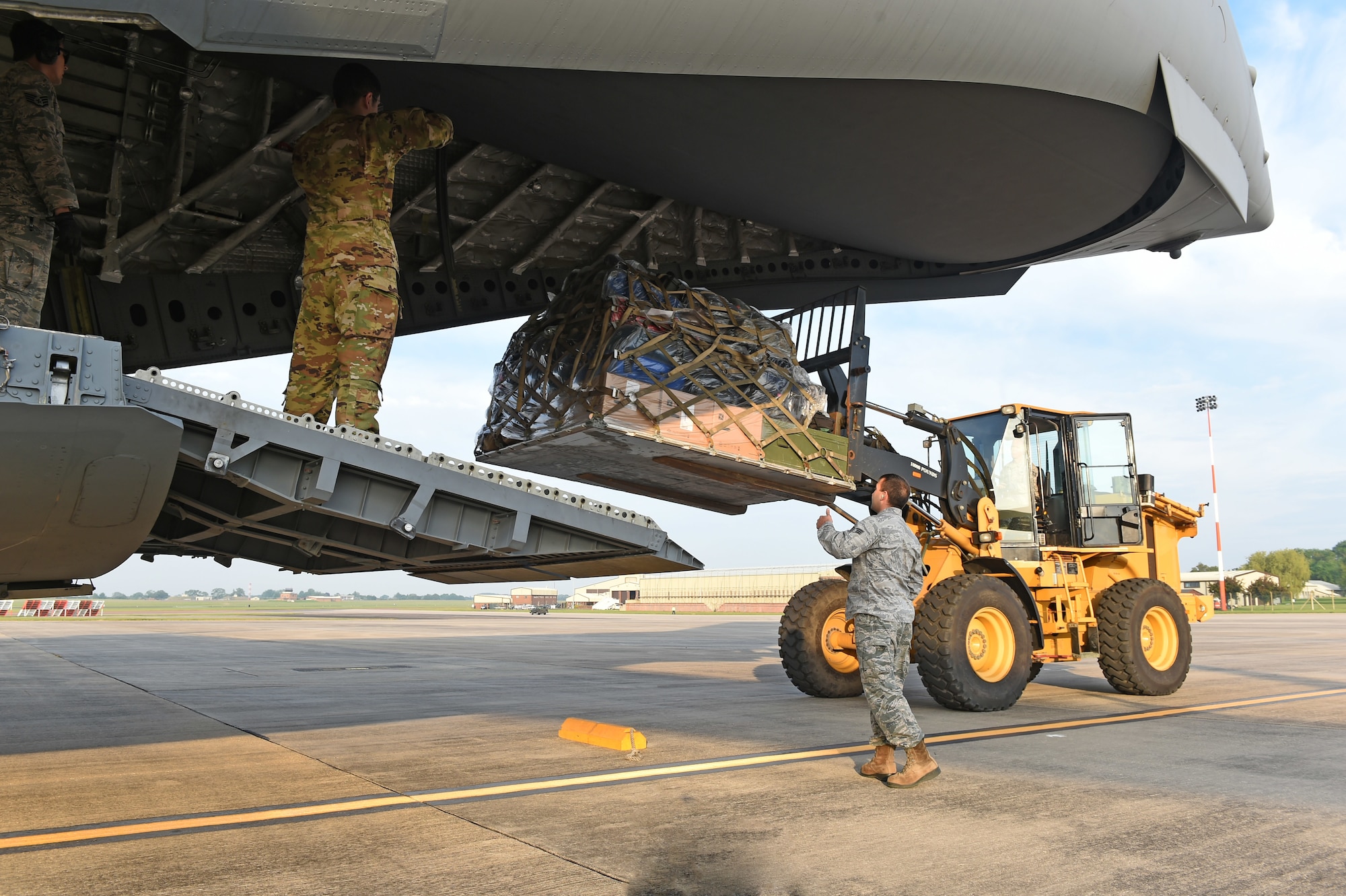 U.S. Air Force Airmen assigned to Air Mobility Command and U.S. Air Forces Europe and Air Forces Africa Command, unload cargo at RAF Fairford, U.K., from a C-17 Globemaster III assigned to Travis AFB, California, May 22, 2018. The C-17 carried approximately 60 Airmen and pallets of cargo in support of Dyess Air Force Base’s 345th Expeditionary Bomb Squadron’s assurance and deterrence missions in Europe. (U.S. Air Force photo by Senior Airman Emily Copeland)