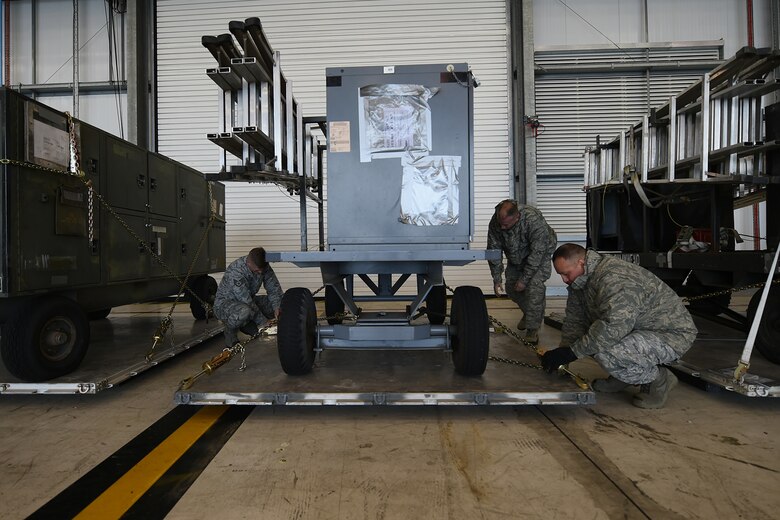 U.S. Air Force Airmen assigned to the 345th Expeditionary Bomb Squadron from Dyess Air Force Base, Texas, de-palletize equipment at RAF Fairford, U.K., May 24, 2018. Members of the 345th EBS will be supporting multiple NATO cross-servicing exercises while forward operating out of RAF Fairford. U.S. Strategic Command bomber units regularly train in support of geographic combatant commands, including U.S. European Command. The flights and training provide opportunities for bomber crews to integrate and train with allies and partners from across the globe. (U.S. Air Force photo by Senior Airman Emily Copeland)
