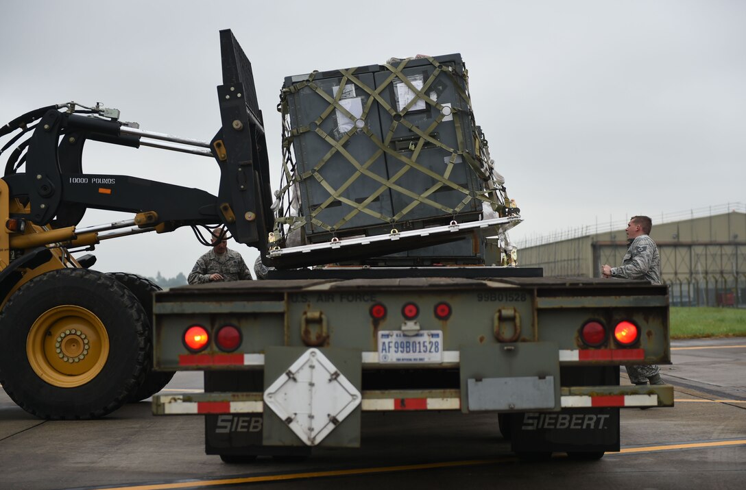 U.S. Air Force Airmen assigned to the 345th Expeditionary Bomb Squadron from Dyess Air Force Base, Texas, load pallets onto a trailer for disbursement at RAF Fairford, U.K., May 24, 2018. Dyess Airmen deployed to the United Kingdom in support of NATO cross-servicing exercises which regularly involve combined theater security engagements with allies and partners, demonstrating the U.S. capability to command, control and conduct bomber missions across the globe. (U.S. Air Force photo by Senior Airman Emily Copeland)
