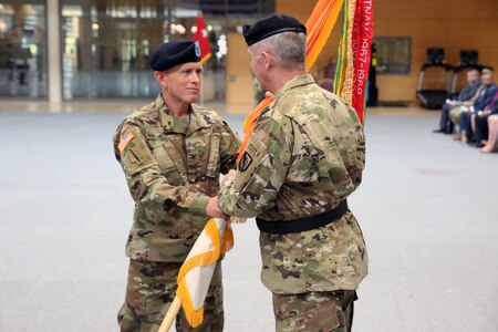 Soldiers passing flag