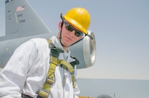 Airman 1st Class Ryan Hobbs, 380th KC-10 crew chief, returns from completing an intake and exhaust inspection on engine 2 of a KC-10 aircraft, Al Dhafra Air Base, United Arab Emirates, May 29, 2018.  . During an inspection, Hobbs checks general hardware, engine and fan blades for any visible damage. (U.S. Air Force photo by Staff Sgt. Ross A. Whitley)