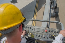Airman 1st Class Ryan Hobbs, 380th KC-10 crew chief, lowers a lift to the ground after completing an I and E or Intake and Exhaust inspection on Engine 2 of a KC-10 aircraft, Al Dhafra Air Base, United Arab Emirates, May 29th, 2018. During an inspection Hobbs checks general hardware, the engine, and fan blades for any visible damage.(U.S. Air National Guard photo by Staff Sgt. Ross A. Whitley)