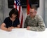 U.S. Air Force Lt. Col. Steven Brummitt, 86th Communications Squadron commander and Sarah Dorosky, 86th Mission Support Group School Liaison Officer sign an Adopt-a-School Partnership Memorandum of Understanding on Ramstein Air Base, Germany, May 31, 2018.