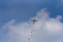 A C-130J Super Hercules passes through the clouds as U.S. and allied paratroopers drop into a field as part of International Jump Week 2018 near Ramstein Air Base, Germany, May 23, 2018. Service members experienced unfavorable weather throughout the week, but it never prevented the 240 U.S. and allied military personnel from dropping.