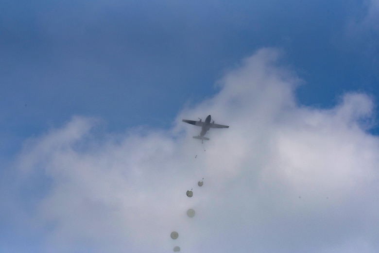 A C-130J Super Hercules passes through the clouds as U.S. and allied paratroopers drop into a field as part of International Jump Week 2018 near Ramstein Air Base, Germany, May 23, 2018. Service members experienced unfavorable weather throughout the week, but it never prevented the 240 U.S. and allied military personnel from dropping.