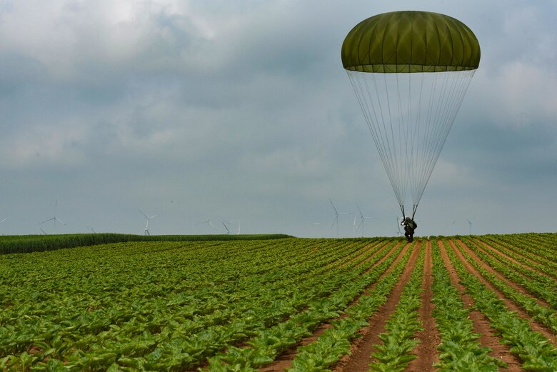 U.S. Army Staff Sgt. Triberious Calhoun lands in a field as part of International Jump Week 2018 near Ramstein Air Base, Germany, May 23, 2018. Calhoun said the week-long event was a positive experience that brought participating countries together to make things in airborne operation more efficient.