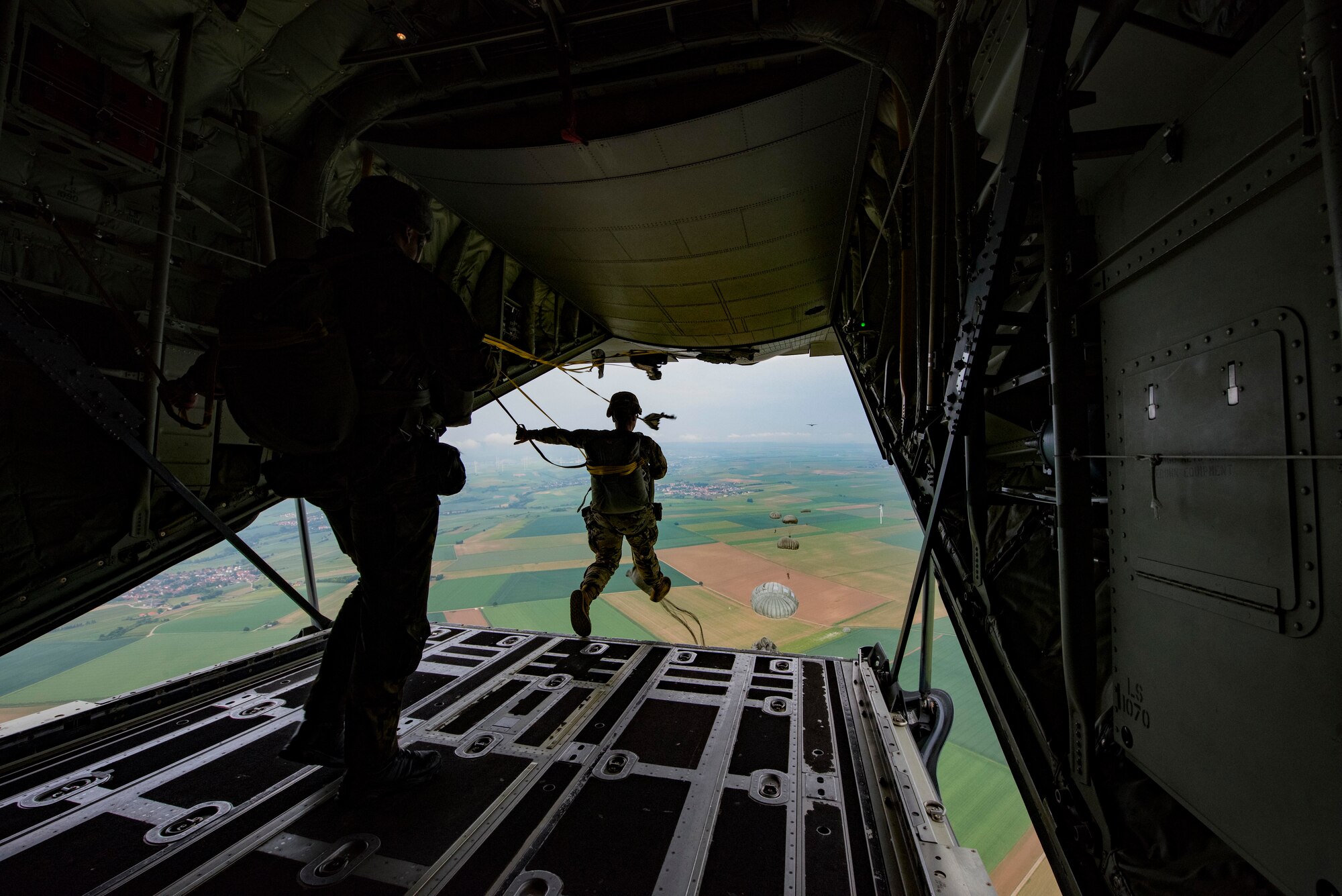 U.S. and allied paratroopers jump from a C-130J Super Hercules as part of International Jump Week 2018 near Ramstein Air Base, Germany, May 22, 2018. The purpose of the annual exercise is to strengthen international relations by working together to standardize techniques, tactics, and procedures for service members when dropping out of aircraft.