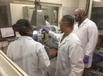 Three US Army soldiers perform fuel quality testing.