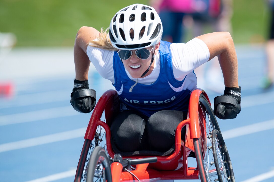 A woman in a wheel chair on a track.