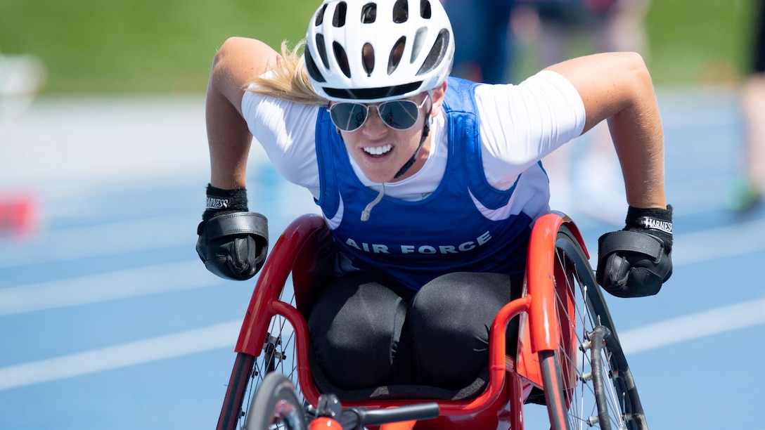 A woman in a wheel chair on a track.