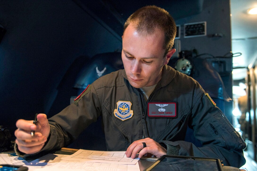 An airman performs preflight checks on a C-5M Super Galaxy.